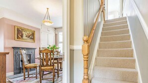 A staircase with wooden balusters and beige carpeted steps. - 2 Bed in Keswick (oc-87732) (Keswick)