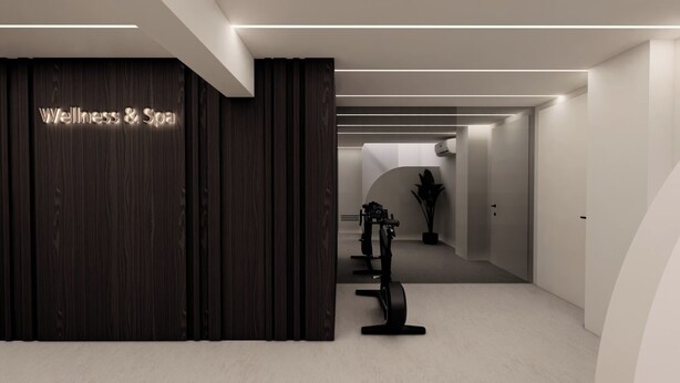 A modern wellness center with a dark wood reception desk, a row of stationary bikes, and a minimalist design.