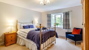 A bedroom with a bed, bedside tables, a chair, a window with curtains, and a ceiling light. - 3 Bed in Bala (oc-88351) (Fron-goch)
