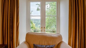 A room with a window, a sofa, and curtains. - 4 Bed in Corwen (oc-88868) (Corwen)