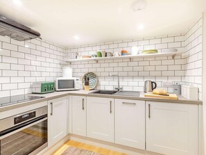 A modern kitchen with white cabinets, a microwave, a toaster, and a sink. - 2 Bed in Taunton (oc-88884) (Isle Brewers)