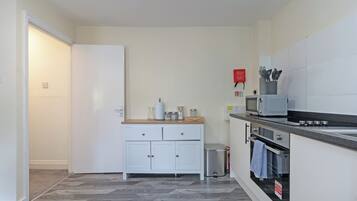Een koffiezetapparaat/waterkoker, een koelkast, een magnetron, een oven