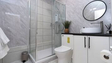 Shower, hair dryer, towels, shampoo
