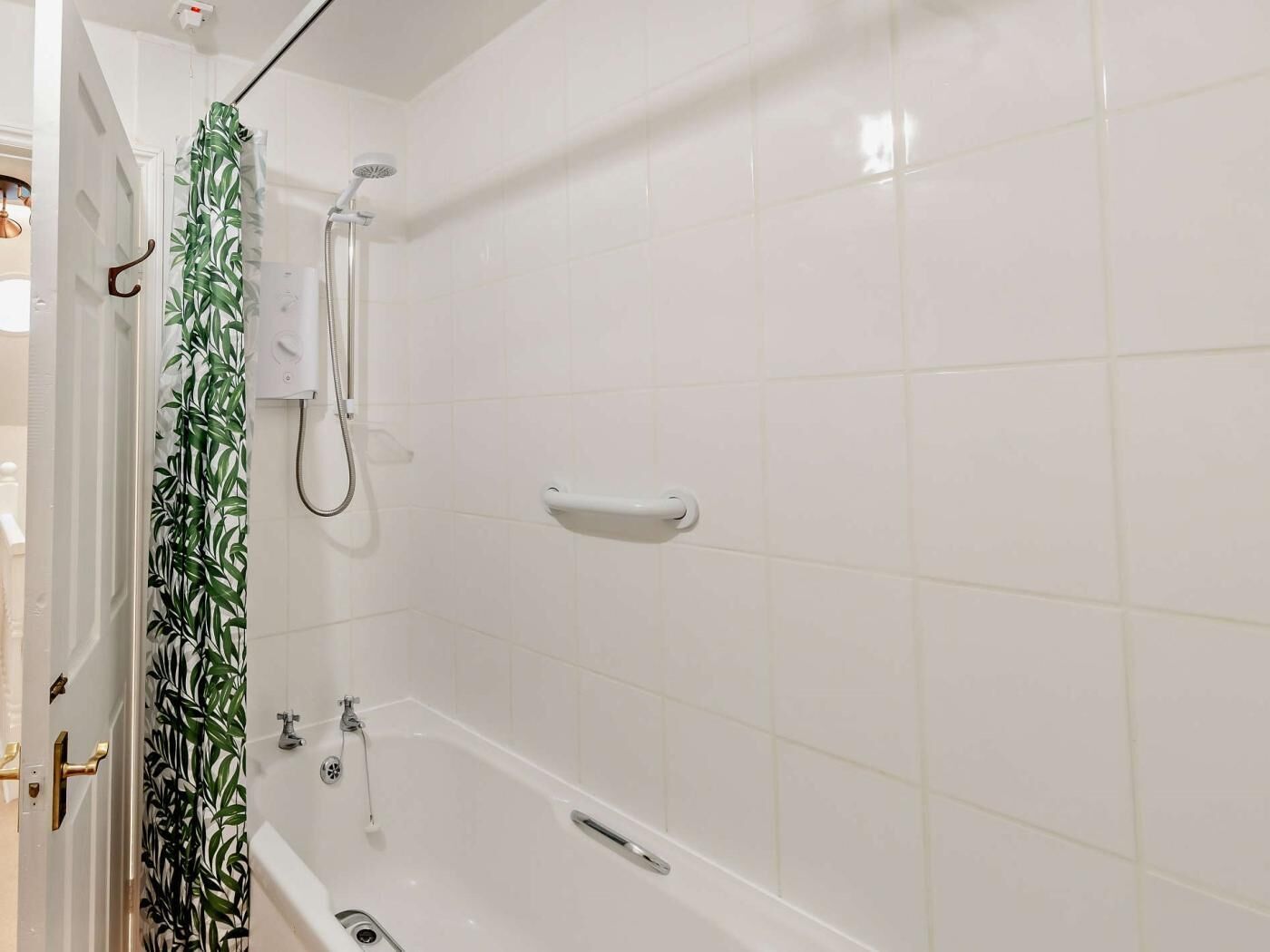 A bathroom with a bathtub, a shower, and a toilet.