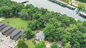 An aerial view of a residential area with a house, a dock, and a boat.