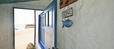 A door with a blue frame, a 'GONE Fishing' sign, and a 'GONE' sign above it.