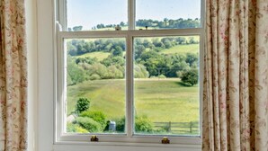 A window with a view of a green landscape, curtains, and a lock. - 3 Bed in Brecon (oc-bn134) (Brecon)