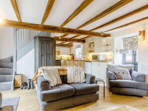 A living room with two sofas, a staircase, and a kitchen in the background. - 2 Bed in Brecon (oc-bn310) (Crai)