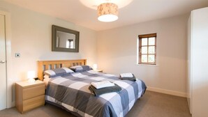 A bedroom with a bed, nightstands, a mirror, a window, and a lamp. - 3 Bed in York (oc-hh015) (Tockwith)