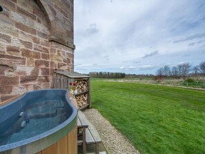 A stone building with a hot tub and a wooden deck. - 1 Bed in Bedale (oc-g0044) (Patrick Brompton)