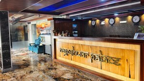 A reception desk with a wooden finish and a sign that reads 'Nagashul Palace.' - Hotel Nageshwar Palace Rajgir (Rajgir)