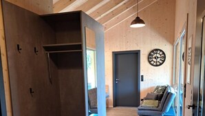 A wooden interior with a built-in bench, a door, and a wall-mounted clock. - Apartment 'Ferienappartement Coleen' with Private Terrace, Balcony and Wi-Fi (Höchst)
