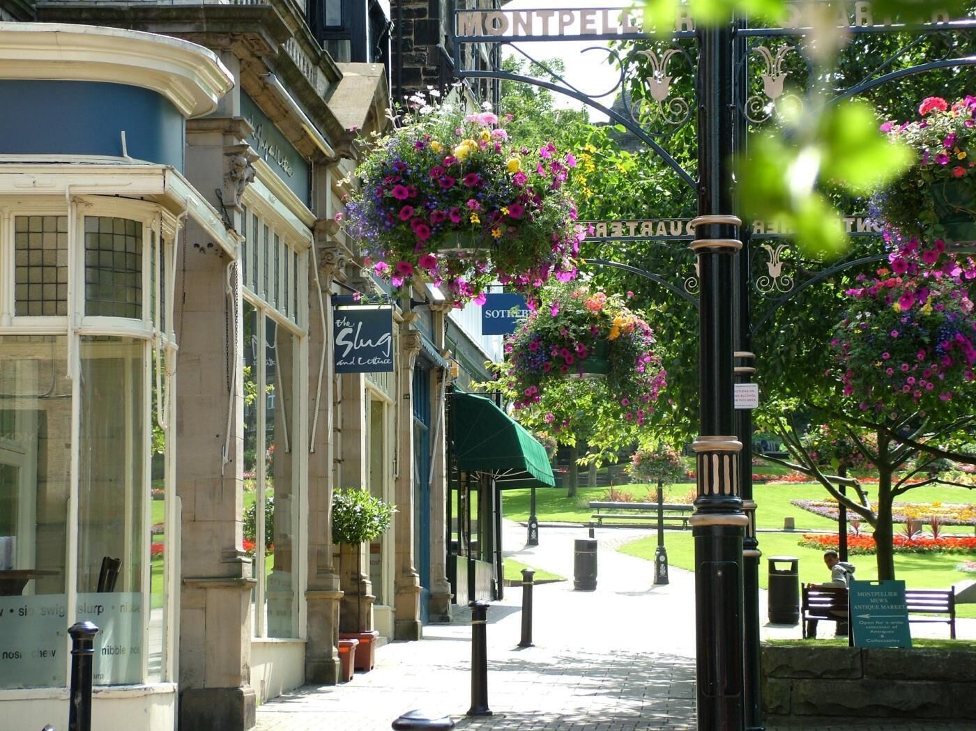 A street with a building labeled 'The Slug and Lettuce' and a sign for 'Montpelier Antiques Market.'