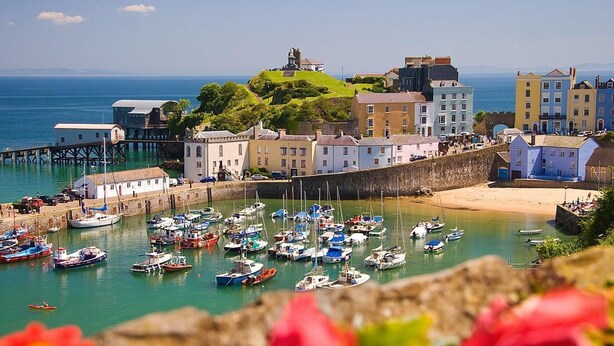 A coastal town with a harbor filled with boats, a pier, and buildings along the waterfront. - 2 Bed in Tenby (oc-fb290) (Tenby)