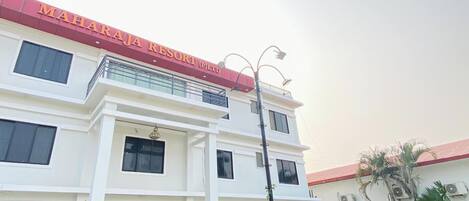 A two-story building with a sign reading 'MAHARAJA RESORT (PVT) LTD.'