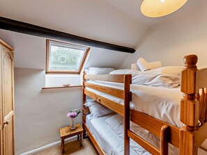 A bunk bed with a skylight, a small table with a vase, and a wooden wardrobe. - 2 Bed in Bideford (oc-saill) (Appledore)