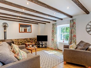 A cozy living room with a stone wall, wooden beams, a fireplace, a television, and two sofas. - 1 Bed in Torrington (oc-annas) (Langtree)
