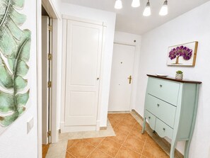 A hallway with a white door, a light green cabinet, and a framed picture on the wall. - Las Dunas, T1 (Punta del Moral)