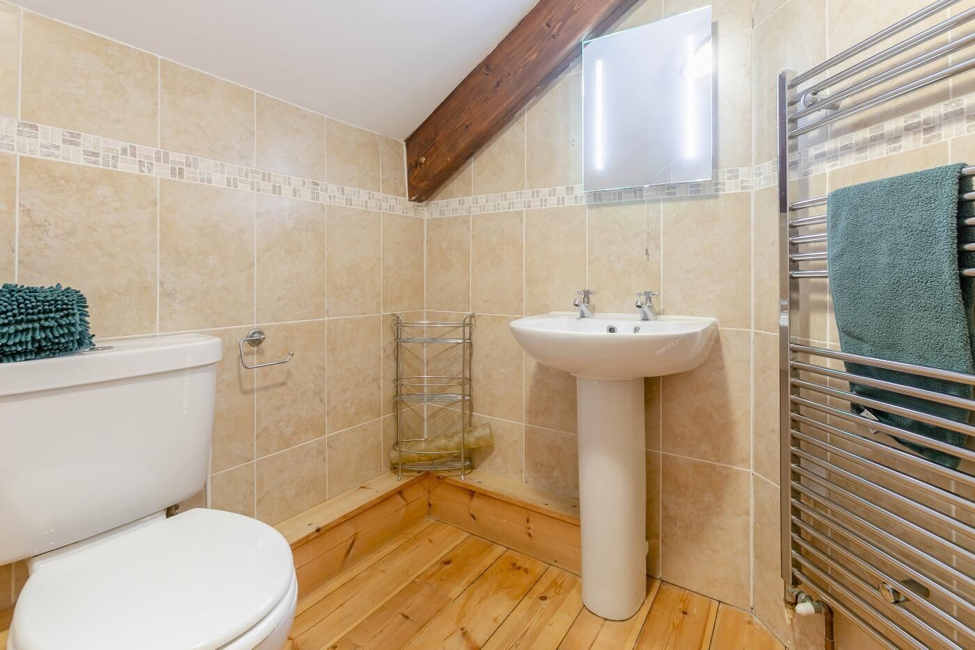 A bathroom with a toilet, sink, and shower area.
