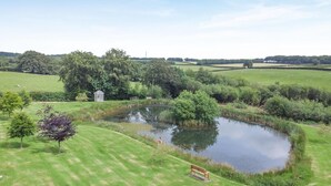 A grassy area with a pond, trees, and a small white structure. - 1 Bed in Taunton (oc-oldli) (Wiveliscombe)