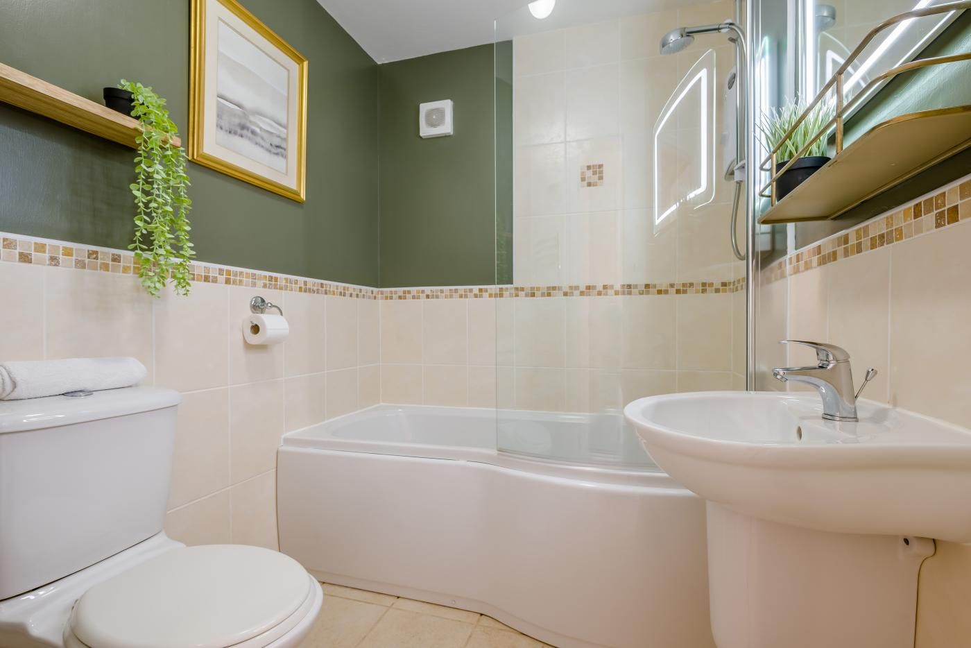 A bathroom with a toilet, a bathtub, and a sink.