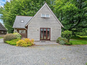 A small, single-story house with a sloped roof, a front porch, and a gravel driveway. - 3 Bed in Camelford (oc-pendw) (Davidstow)
