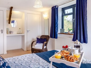 A hotel room with a bed, a chair, a tray with breakfast items, and a window with curtains. - 3 Bed in Lifton (oc-tcoah) (Broadwoodwidger)