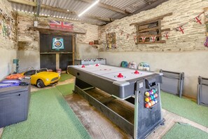 A room with a foosball table, a yellow sports car, and a target on the wall. - 2 Bed in Liskeard (oc-04708) (Menheniot)
