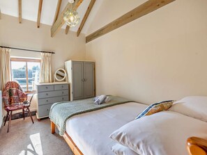 A bedroom with a bed, a dresser, a chair, a wardrobe, and a window with curtains. - 3 Bed in Bude (oc-woodu) (Poundstock)