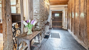 A rustic interior with exposed stone walls, wooden beams, and a stone fireplace. - 6 Bed in Winkleigh (oc-furfa) (Iddesleigh)