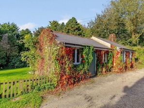 Ein Haus mit einem Schotterweg und einem Holzzaun.