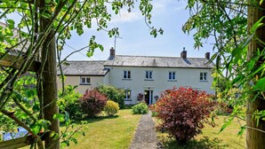 A two-story house with a gravel pathway leading to the entrance. - 4 Bed in Barnstaple (oc-05560) (Kentisbury)
