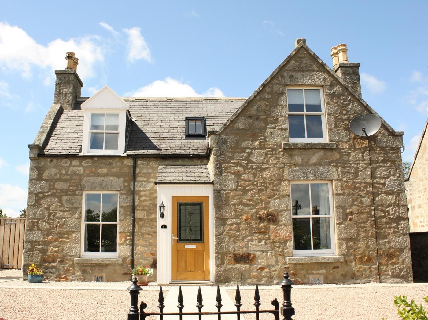 A stone house with a wooden door, two windows, and a satellite dish.