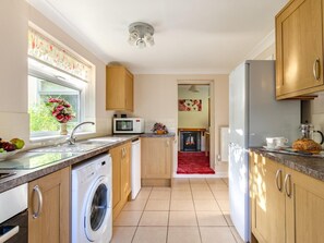 A kitchen with a washing machine, microwave, and refrigerator. - 2 Bed in Dereham (oc-shrn8) (Scarning)