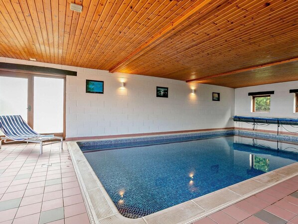 An indoor swimming pool with tiled walls, wooden ceiling, and a lounge chair. - 2 Bed in Holmfirth (oc-emley) (New Mill)