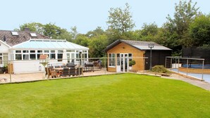 A residential property with a large lawn, a conservatory, a wooden shed, and a swimming pool. - 10 Bed in Lampeter (oc-pontv) (Lampeter)