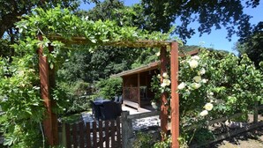 A wooden pergola with climbing plants and a table with chairs underneath. - 2 Bed in Barnstaple (oc-28959) (Newton Tracey)