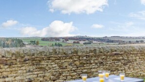 A stone wall with a picnic table and glasses of orange juice. - 3 Bed in Consett (oc-29408) (Lanchester)