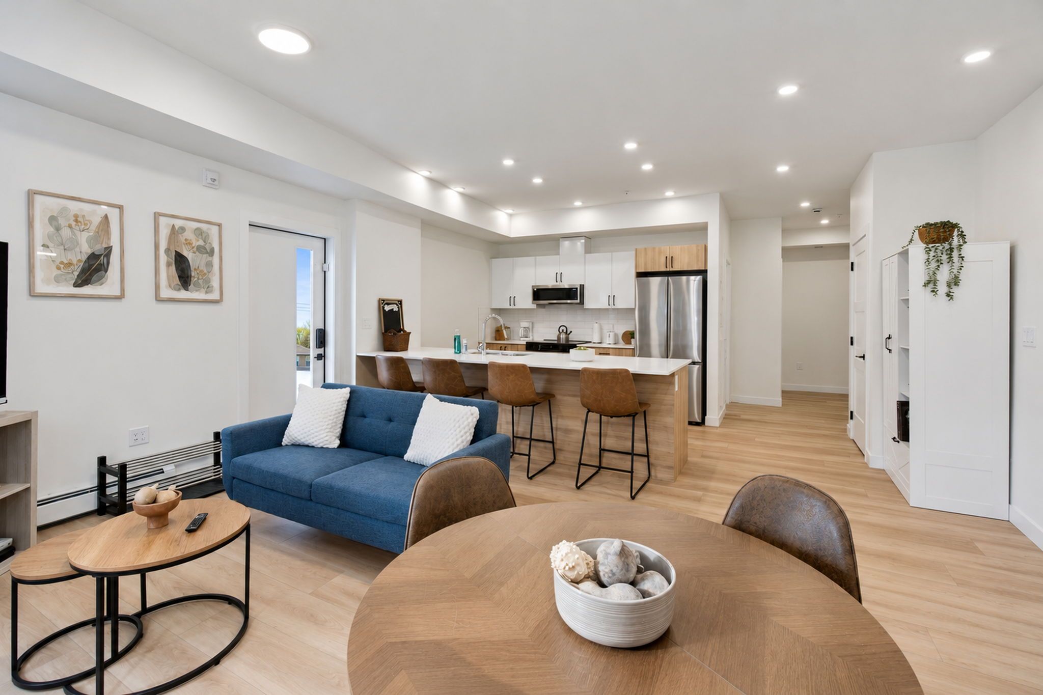 A modern apartment with a living room, kitchen, and dining area.