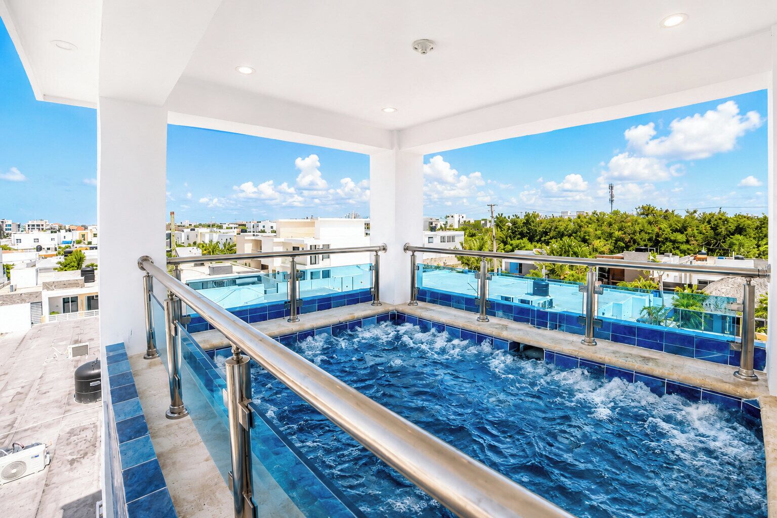 A rooftop infinity pool with a clear view of the cityscape.