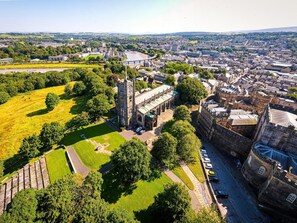 An aerial view of a historic town with a prominent church, a river, and surrounding greenery. - 3 Bed in Poulton-le-fylde (oc-41764) (Stalmine)
