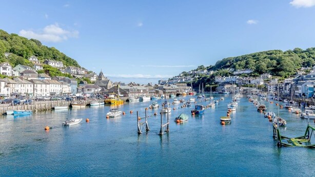 A harbor with numerous boats docked, surrounded by buildings and hills. - 1 Bed in Par- (oc-42007) (Par)