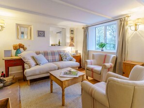 A cozy living room with a sofa, armchairs, a coffee table, and a side table. - 4 Bed in Monmouth (oc-42868) (Cwmcarvan)