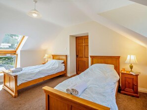 A bedroom with two wooden beds, a skylight, a wooden wardrobe, and a nightstand with a lamp. - 2 Bed in Conwy (oc-42573) (Ty'n-y-groes)
