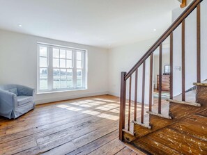 A room with a large window, wooden flooring, a chair, and a staircase. - 8 Bed in Kington (oc-42962) (Titley)