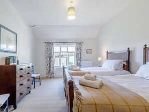 A bedroom with a bed, a dresser, a chair, and a window with curtains. - 8 Bed in Kington (oc-42962) (Titley)