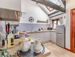 A modern kitchen with a skylight, a clock, and a refrigerator. - 3 Bed in Looe (oc-43128) (Saint Martin-by-Looe)