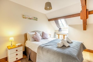 A bedroom with a bed, bedside table, lamp, and a window with a view. - 3 Bed in Whitchurch Canonicorum (oc-43398) (Whitchurch Canonicorum)