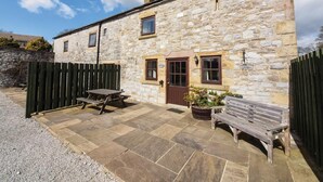 A stone building with a door, windows, and a wooden fence. - 2 Bed in Ashford In The Water (oc-pk502) (Ashford in the Water)