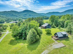 A rural property with a large house, a barn, and surrounding greenery. - Twin Cub Lodge, 3 Br, 2 Ba, Sleeps 8 & Hot Tub (Townsend)